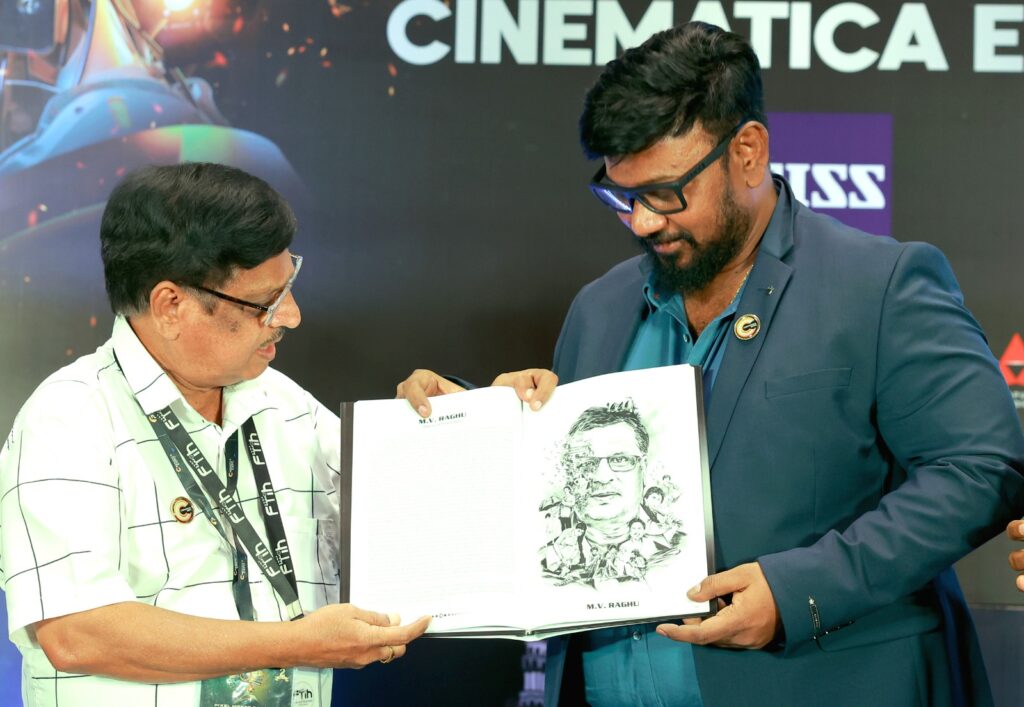 P.G Vinda presents and showing the Visual Storytellers book to renowned cinematographer M.V. Raghu